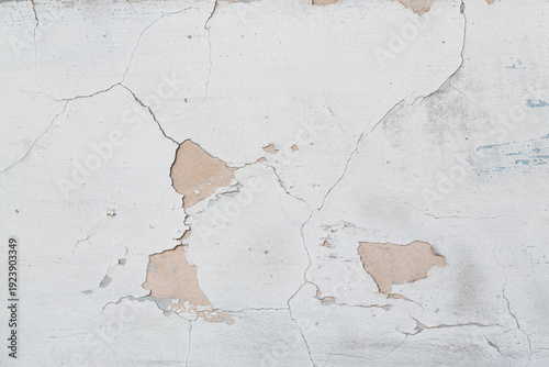 Old wall with cracked plaster. Weathered rough surface. Vintage texture is perfect for background and design.