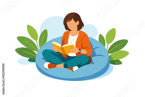 Woman reading a book while sitting on a beanbag chair.