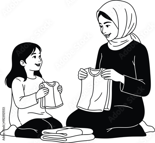 Woman and child folding laundry together on the floor