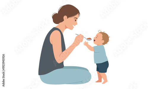 Mother feeding happy baby with spoon, toddler eating mealtime