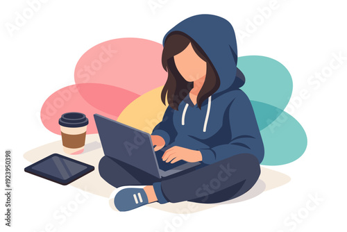 Young woman wearing a hoodie working on a laptop computer.