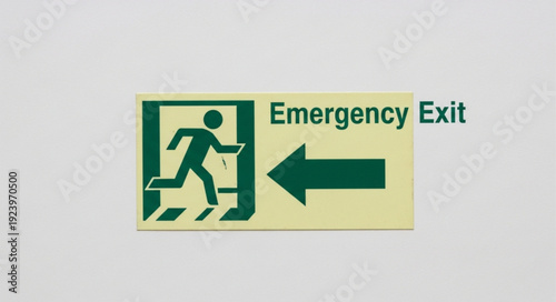 Emergency exit sign indicating direction for safe evacuation during emergencies and disasters.