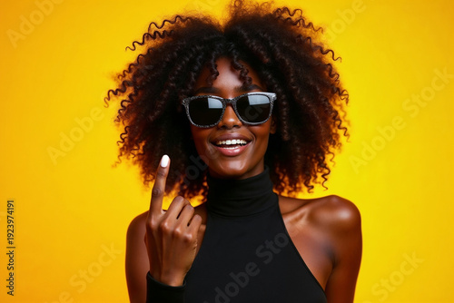 Wallpaper Mural Stylish Young Woman with Curly Hair Wearing Sunglasses on Bright Yellow Background Torontodigital.ca