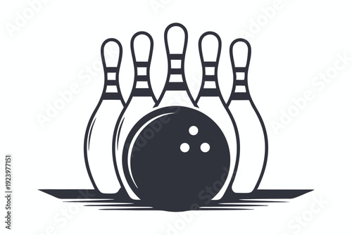 A black and white bowling ball sits before the arranged bowling pins on lane