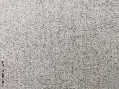 High-quality close-up of a seamless grey felt texture with a soft, heathered finish. The dense, non-woven fibrous surface creates a clean, neutral background perfect for minimalist design, industrial 
