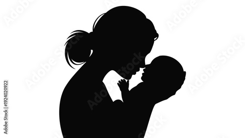 Mother kissing baby silhouette of woman holding and kissing newborn loving parent and child moment