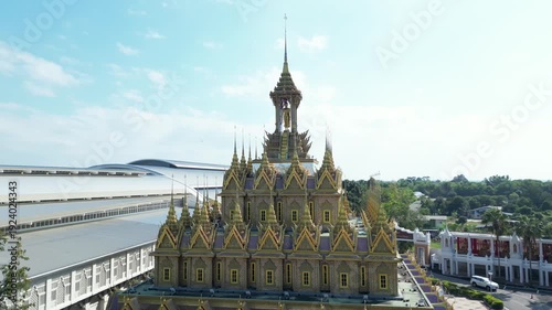Thai Temple Architecture Aerial View with Ornate Golden Spires and Courtyard Under Blue Sky