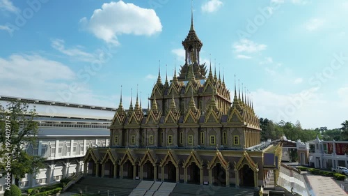 Thai Temple Architecture Aerial View with Ornate Golden Spires and Courtyard Under Blue Sky