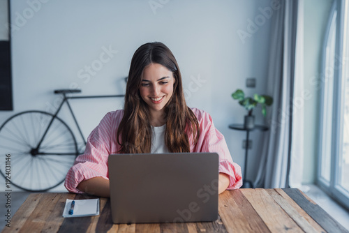 Photography Happy young woman sit at desk look at laptop screen browsing surfing wireless In