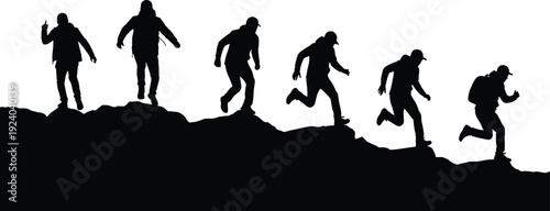 Silhouette of seven people running and climbing on rocky terrain