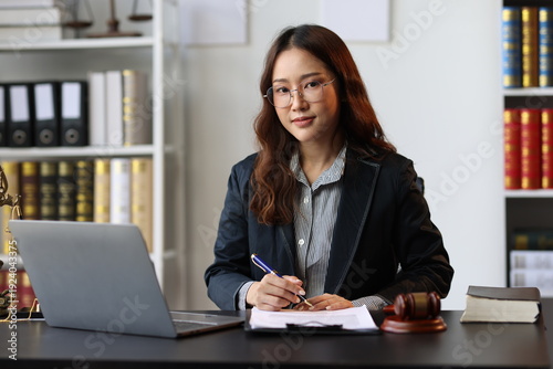 Konstfotografi Asian female lawyer reviewing legal documents, providing legal advice and counsel to clients