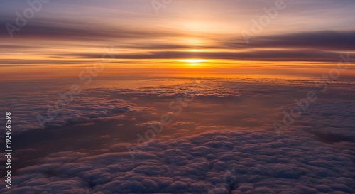 Dramatic sunrise over misty ocean waves with golden light reflection