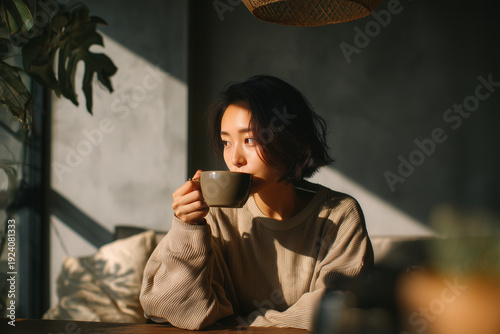 Woman enjoying coffee in cozy cafe with natural light and plants