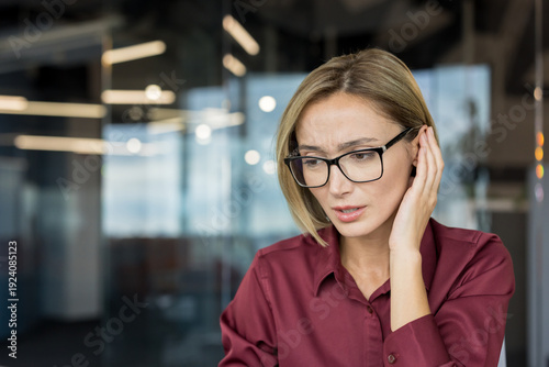 Slika na platnu Adult businesswoman in glasses cupping ear, struggling to hear or understand a c