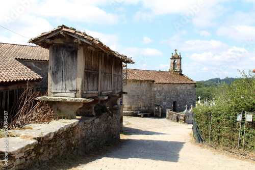 Iglesia de San Xiao do Camino and cross on the road in O Coton Palas de Rei July 2024