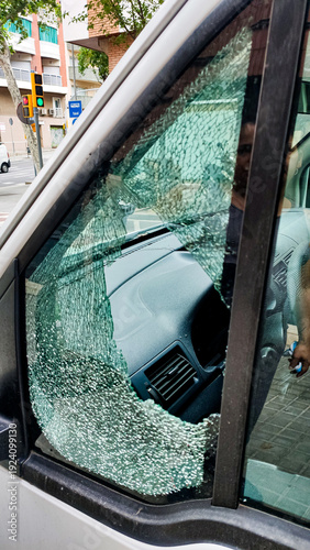 broken car window after burglary and theft, safety and criminal activity of parked car