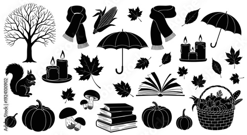 Collection of autumn themed objects including leaves pumpkins and books
