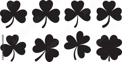 Multiple black shamrock and four leaf clover silhouettes symbolizing good luck and Irish tradition on white