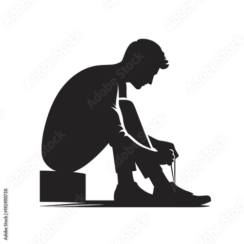 Man sitting and tying shoelaces in contemplative pose