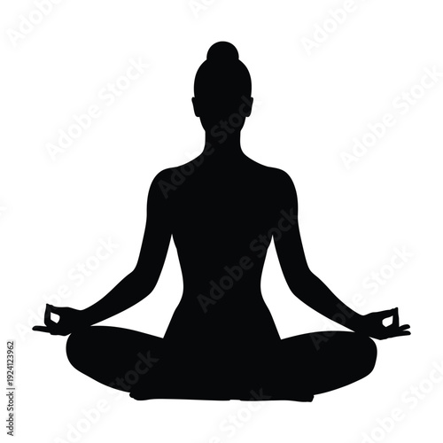 Silhouette of a woman practicing yoga in a meditative pose