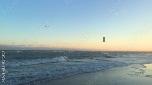 Silhouette of Kitesurfer Jumping Over Waves at Golden Hour
