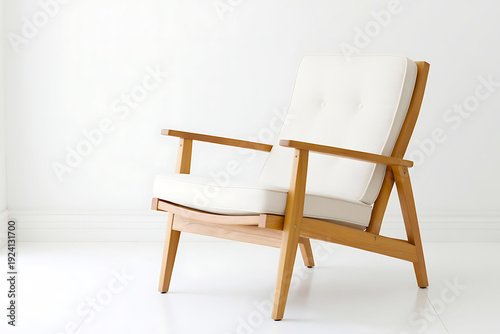 Contemporary wooden armchair with clean lines and comfortable white cushions, perfect for modern interiors, showcased against a white wall.