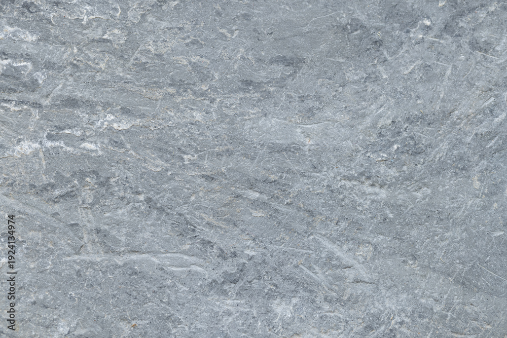 Obraz premium Natural Grey Slate Stone Texture Background with Scratched Surface,High-resolution close-up of a natural grey stone surface with rough texture, subtle mineral veins, and organic scratch patterns.