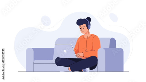 Young person with headphones using laptop on sofa, remote work, online learning, modern lifestyle