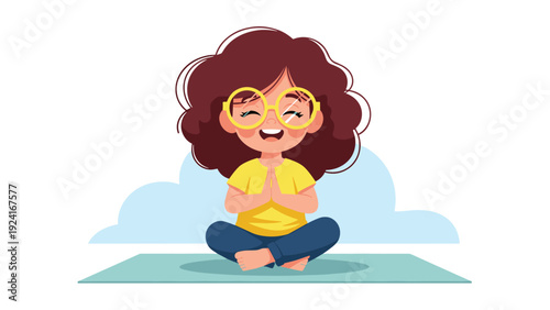 Young girl with glasses and curly hair practices yoga meditation while sitting in a lotus pose on a mat with closed eyes for relaxation.
