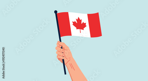Person's hand holding the waving national flag of Canada with its red maple leaf symbol against a light blue background.