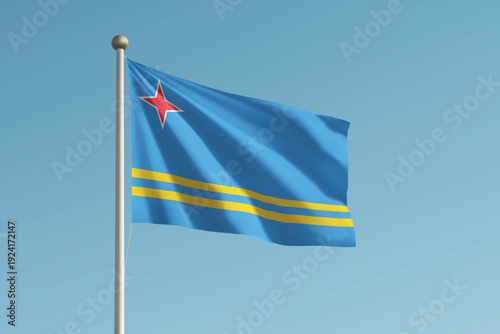 Aruba national flag waving on pole against clear blue sky background.