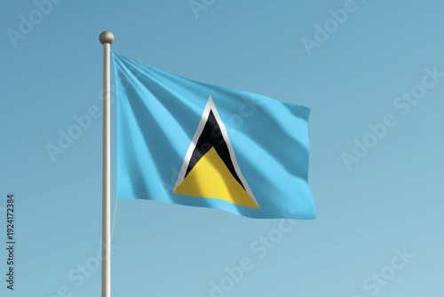 Saint Lucia national flag waving on pole against clear blue sky background.