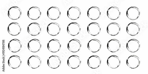 Arrangement of silver metal rings in a grid pattern on white