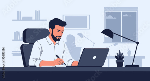 Man working on laptop at office desk.