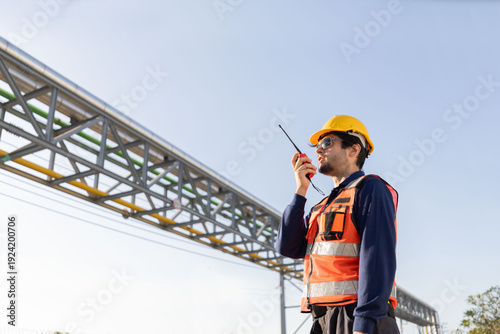 Petroleum engineers with hardhat working at oil refinery site