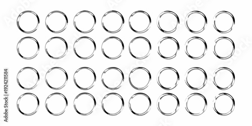 Arrangement of silver metal rings in a grid pattern on white