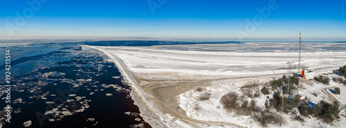 Obraz na plátně Aerial view shows the Daugava River meeting the Baltic Sea at Mangalsala, Riga