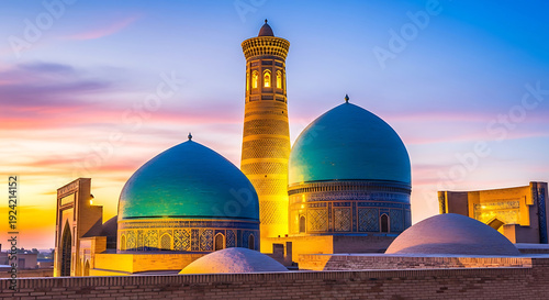 Islamic minaret and turquoise domes at sunset mosque