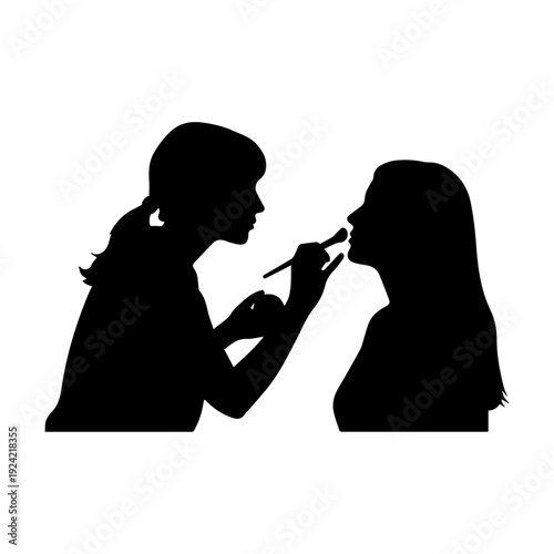 Professional makeup artist applying makeup to a client's face silhouette.