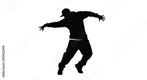 Silhouette of a person with arms outstretched appearing to dance or leap
