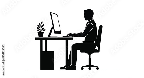 A silhouette of a person working at a desk with a computer
