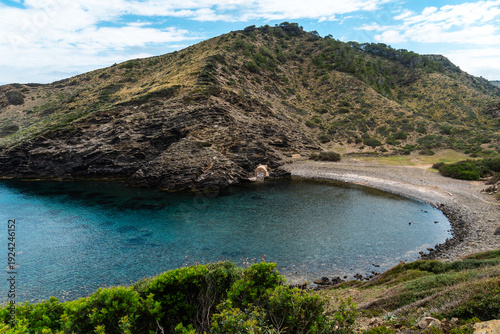 Wallpaper Mural Scenic view of a secluded cove in Menorca with crystal clear waters and lush greenery. Torontodigital.ca
