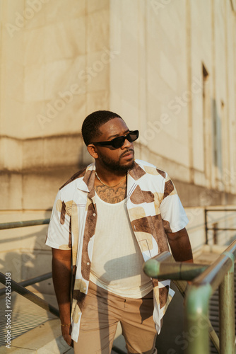 Portrait Of A Man Outside Wearing Sunglasses Coming Up Stairs