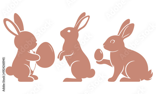 Three pink easter bunnies sitting with eggs, Easter day concept 