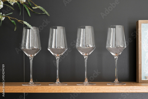 Kitchen Tableware Collection with Wine Glasses on a black background and some plant showing