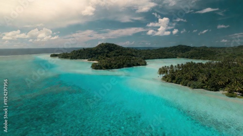 Tropical island paradise with turquoise waters and lush green forests.