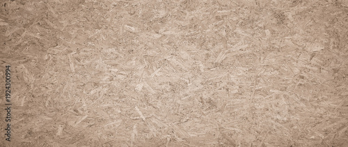 Foto OSB boards made of brown wood chips sanded into wooden background