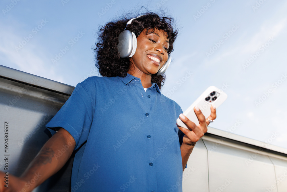© Artem Podrez/Stocksy - Portrait Smiling Woman Using Phone Under Blue Sky © Artem Podrez/Stocksy - Portrait Smiling Woman Using Phone Under Blue Sky