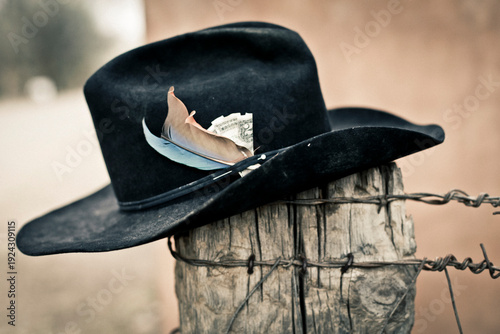 Galisteo, New Mexico, USA. cowboy hat on a fence post with a $2 bill in the headband