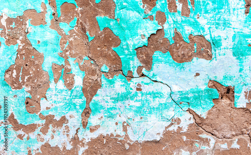 Texture of old wall with cracks and peeling paint. Cracked grunge wall background